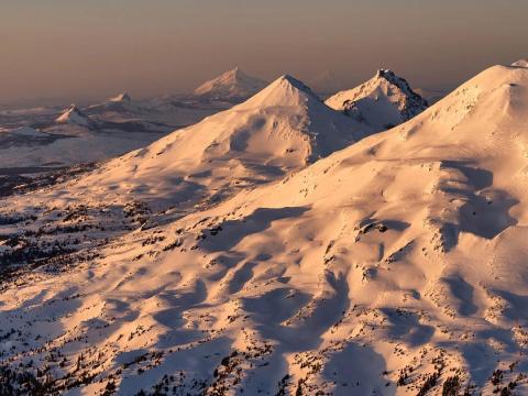 An aerial image of snow-capped mountains.